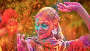 Woman painted festive colours dancing